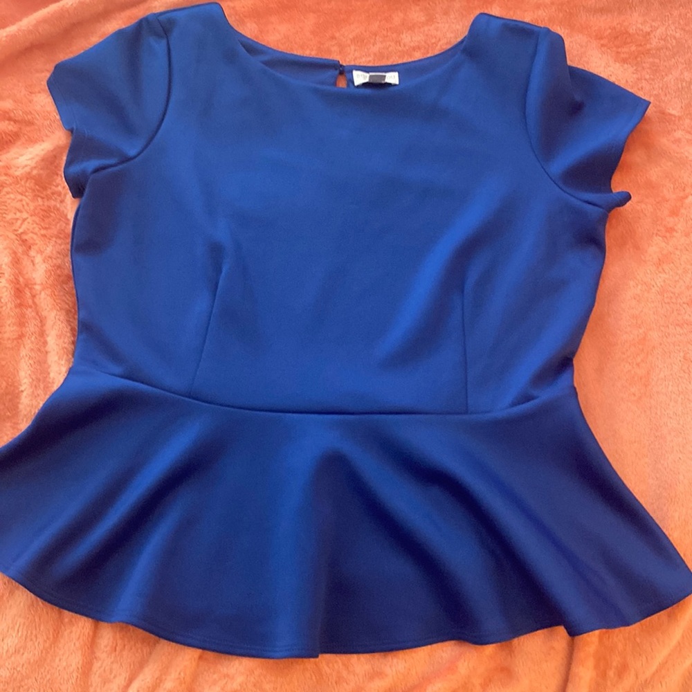 Ladies Royal blue polyester/spandex XL top. Flutter design at waist.